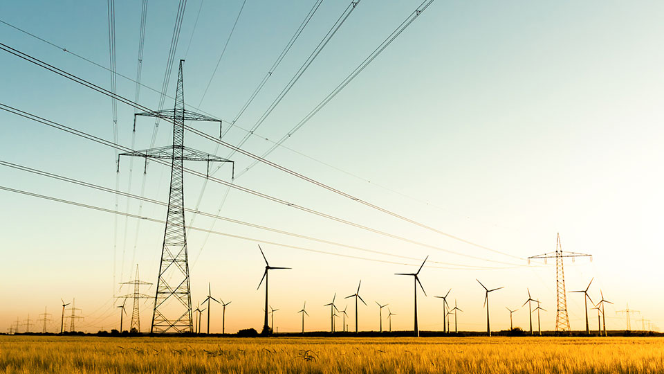 wind turbines and power lines over a field