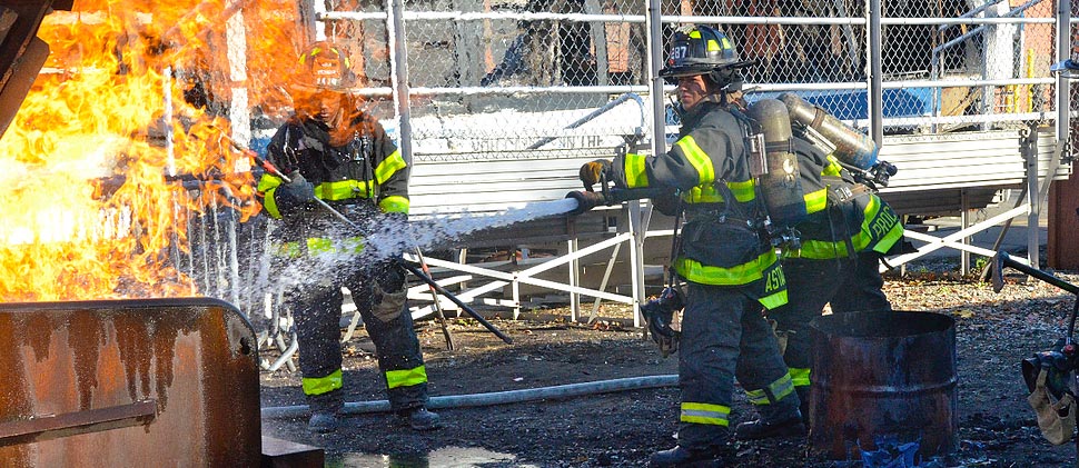 Three women put out fire in barrel using firehose